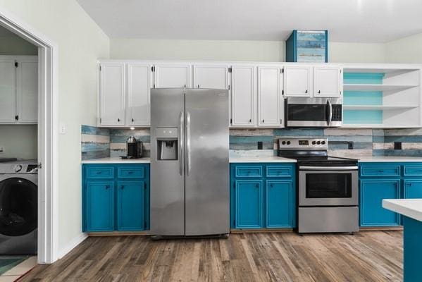 14154 Cutlass Ave, Corpus Christi, TX 78418 - kitchen featuring stainless steel appliances, washer / dryer, blue cabinetry, dark wood-style flooring, and backsplash
