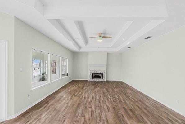 14154 Cutlass Ave, Corpus Christi, TX 78418 - unfurnished living room with a raised ceiling, wood finished floors, ceiling fan, and a fireplace