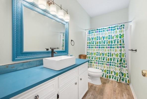 14154 Cutlass Ave, Corpus Christi, TX 78418 - bathroom with vanity, wood finished floors, and a shower with curtain