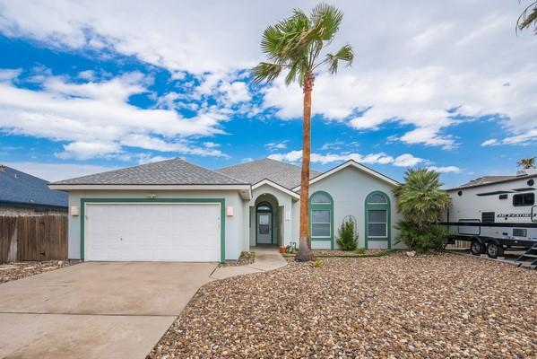 14154 Cutlass Ave, Corpus Christi, TX 78418 - ranch-style house featuring concrete driveway, an attached garage, and stucco siding