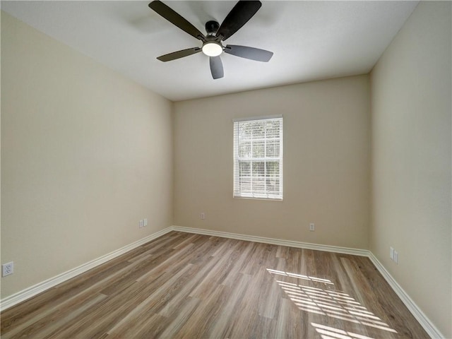 unfurnished room with light wood-type flooring and ceiling fan