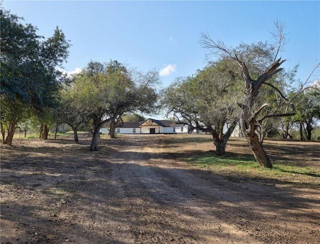 view of front of home with a rural view