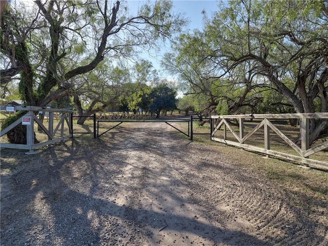 view of gate with a rural view