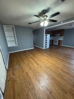 unfurnished living room with baseboards, a textured ceiling, a ceiling fan, and wood finished floors