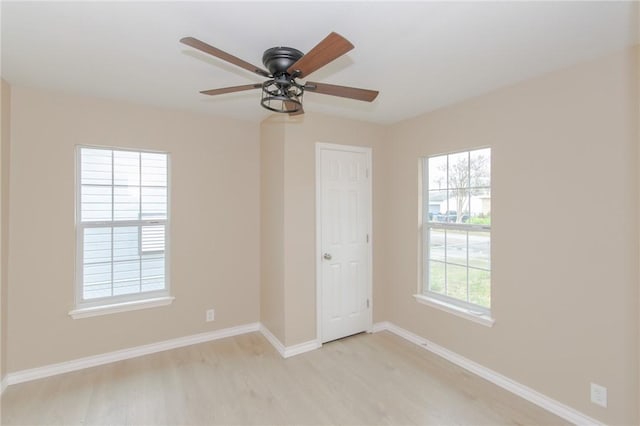 spare room with light wood-type flooring and ceiling fan