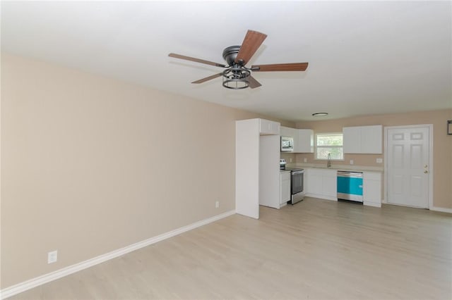 unfurnished living room featuring ceiling fan, light hardwood / wood-style floors, and sink