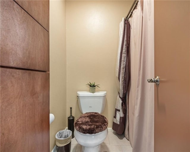 bathroom with tile patterned flooring and toilet