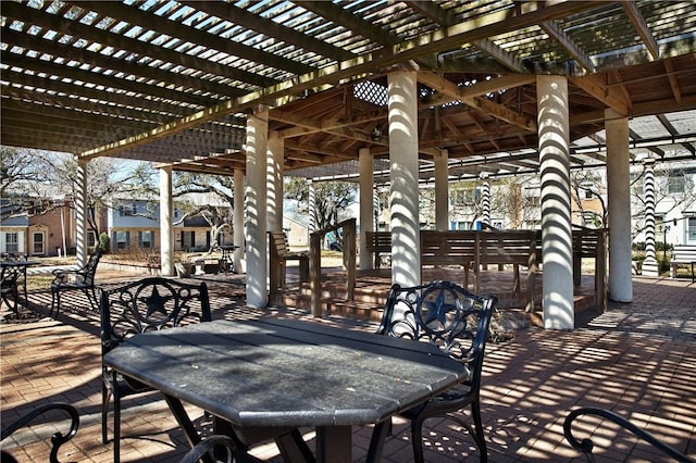 view of patio with a residential view, outdoor dining area, and a pergola