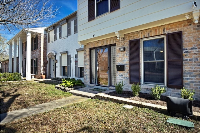 doorway to property featuring brick siding