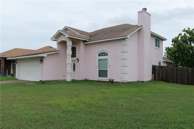 view of front of home with a front lawn and a garage