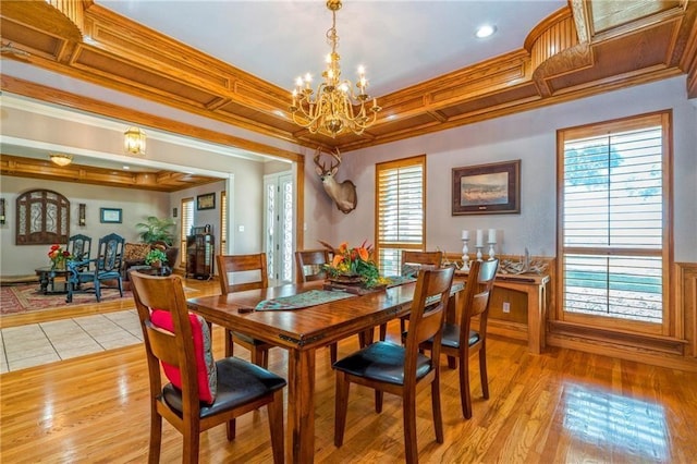 dining room with crown molding and light hardwood / wood-style floors