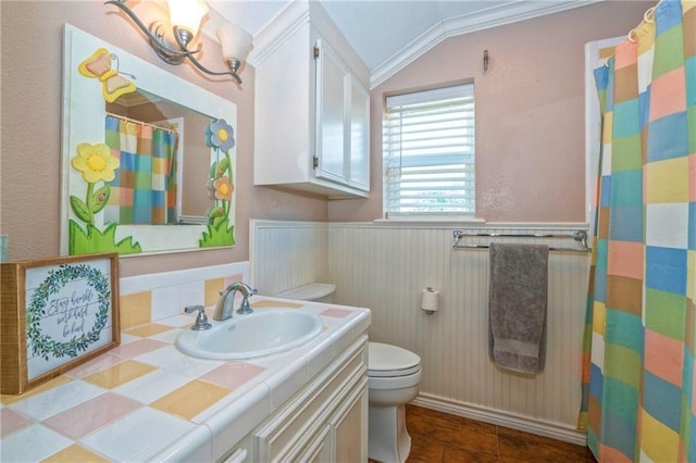 bathroom with vanity, crown molding, vaulted ceiling, and toilet