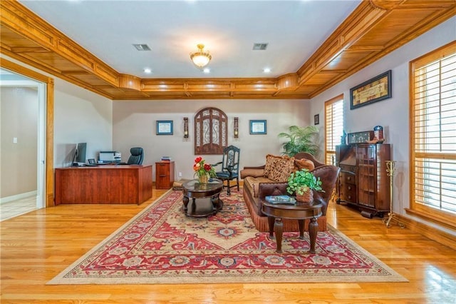 living room with crown molding and light wood-type flooring