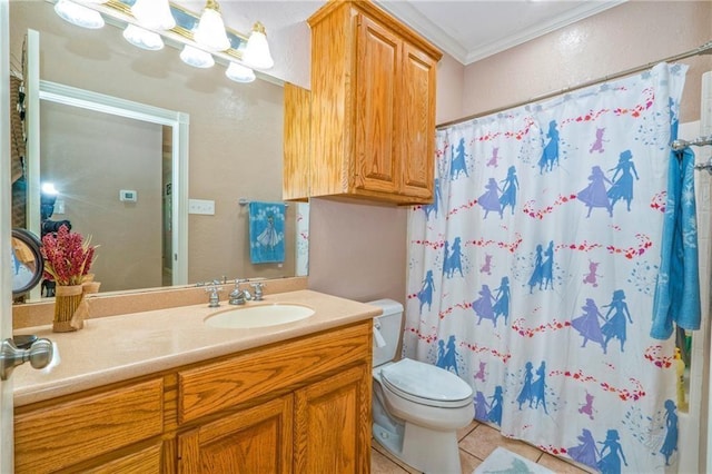 bathroom featuring tile patterned flooring, vanity, crown molding, and toilet