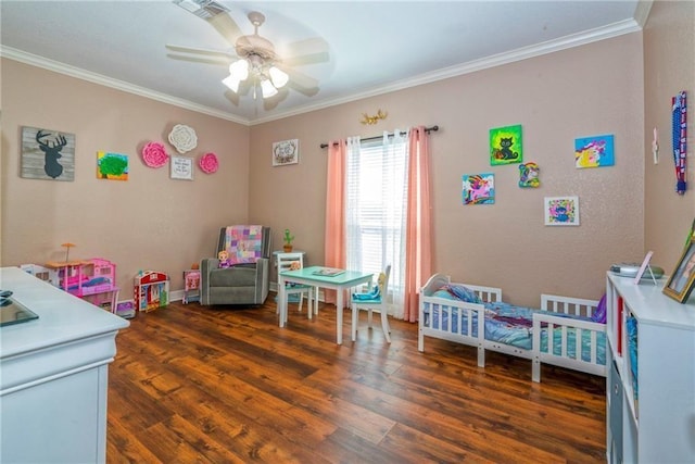 rec room with ornamental molding, dark hardwood / wood-style floors, and ceiling fan