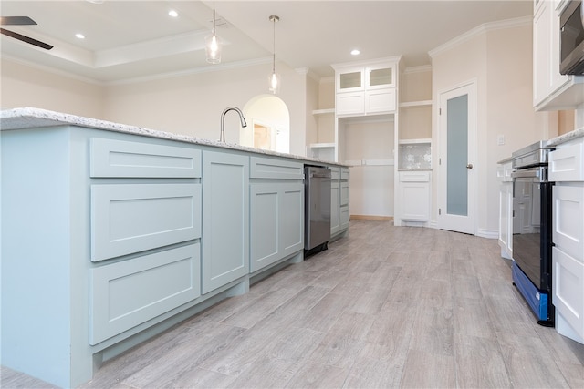 kitchen with ceiling fan, light stone countertops, decorative light fixtures, white cabinets, and ornamental molding