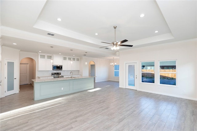 kitchen with white cabinetry, sink, a raised ceiling, light hardwood / wood-style flooring, and appliances with stainless steel finishes