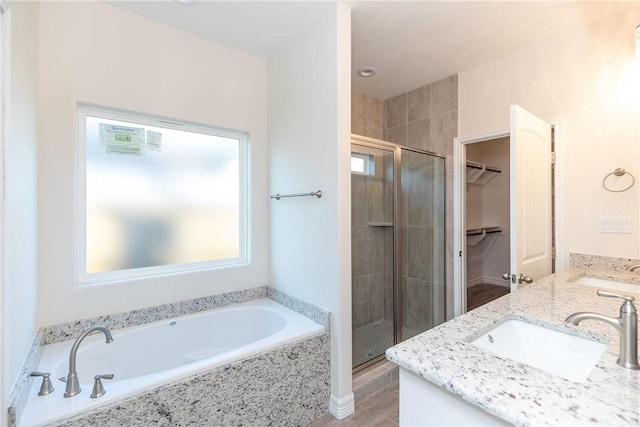 bathroom with vanity, separate shower and tub, and wood-type flooring