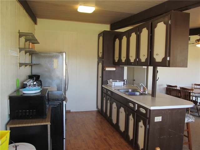 kitchen featuring dark wood-type flooring, sink, dark brown cabinets, and wooden ceiling