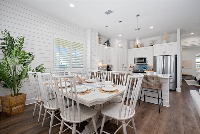 dining room featuring dark hardwood / wood-style floors and sink