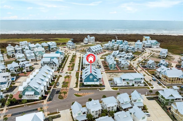 birds eye view of property with a water view and a view of the beach