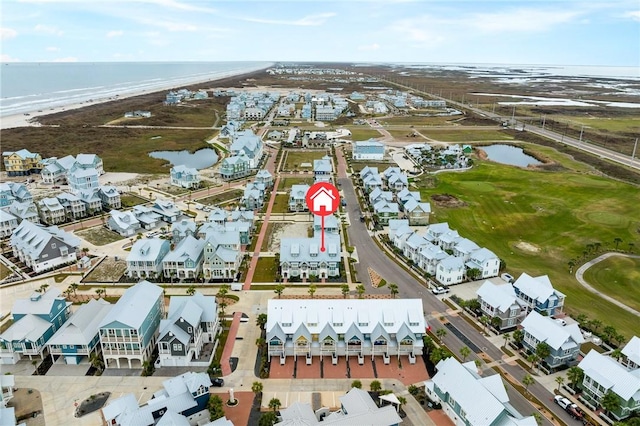 drone / aerial view featuring a view of the beach and a water view