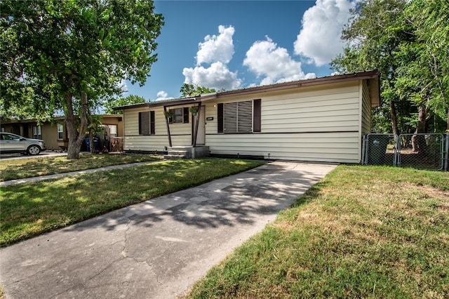 ranch-style home with a front yard