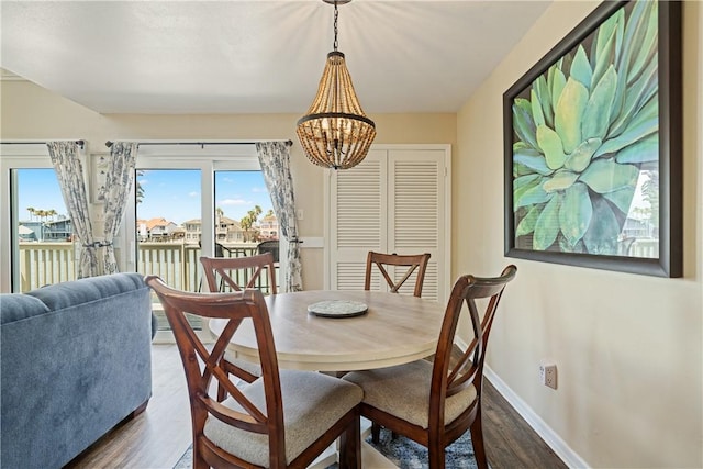 14300 Aloha St Unit 134, Corpus Christi, TX 78418 - dining room with dark wood-type flooring, plenty of natural light, and a chandelier