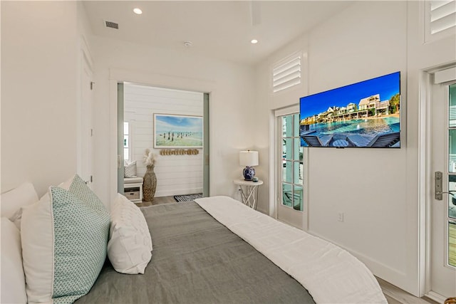 bedroom featuring hardwood / wood-style flooring and access to outside