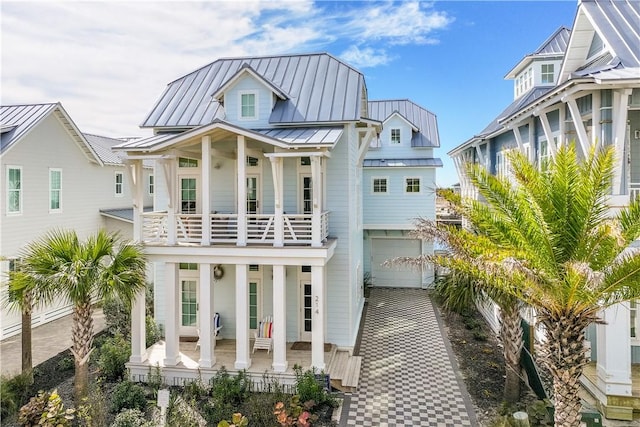 view of front of home featuring a balcony, a garage, and a porch