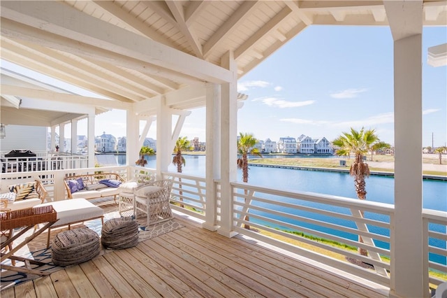 deck featuring an outdoor hangout area and a water view