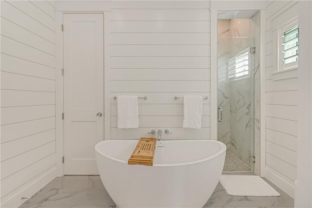 bathroom with wooden walls and separate shower and tub