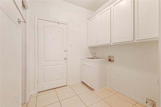 13534 Bullion Ct, Corpus Christi, TX 78418 - washroom with hookup for a washing machine, light tile patterned floors, cabinet space, and baseboards