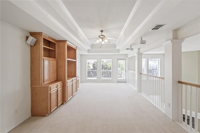 13534 Bullion Ct, Corpus Christi, TX 78418 - unfurnished living room featuring crown molding, a ceiling fan, light carpet, a raised ceiling, and ornate columns