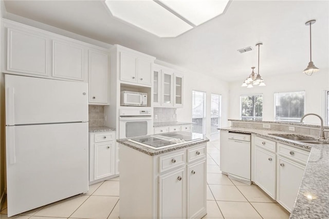 13534 Bullion Ct, Corpus Christi, TX 78418 - kitchen with white appliances, a sink, a center island, white cabinetry, and backsplash