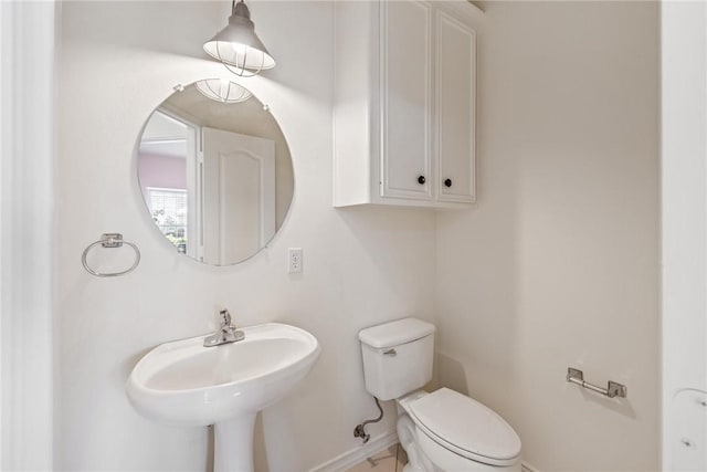 13534 Bullion Ct, Corpus Christi, TX 78418 - half bath featuring toilet, a sink, and baseboards