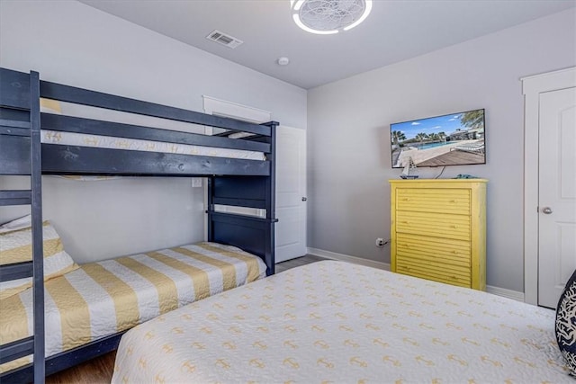 bedroom with dark hardwood / wood-style flooring