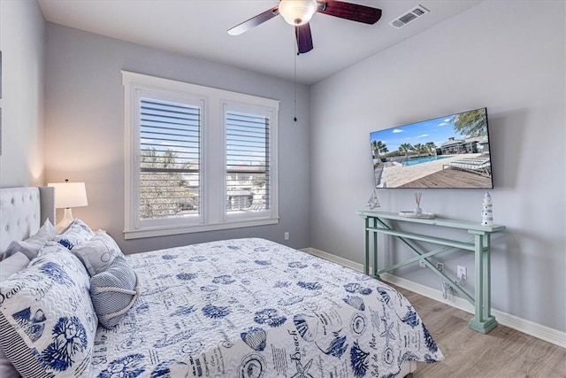 bedroom with ceiling fan and light hardwood / wood-style flooring