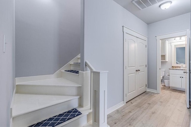 stairs with wood-type flooring