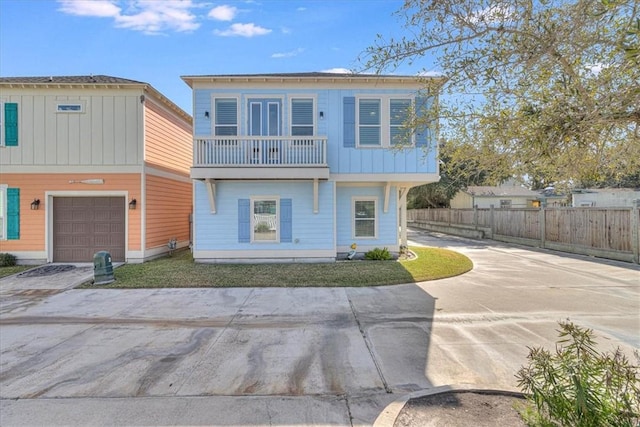 view of front of home with a garage and a balcony