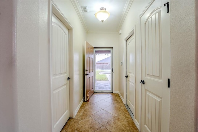 doorway to outside featuring light tile patterned floors and ornamental molding