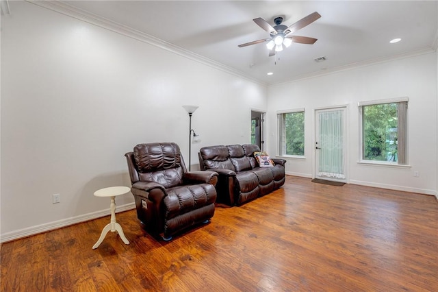 living room with ceiling fan, wood-type flooring, and ornamental molding