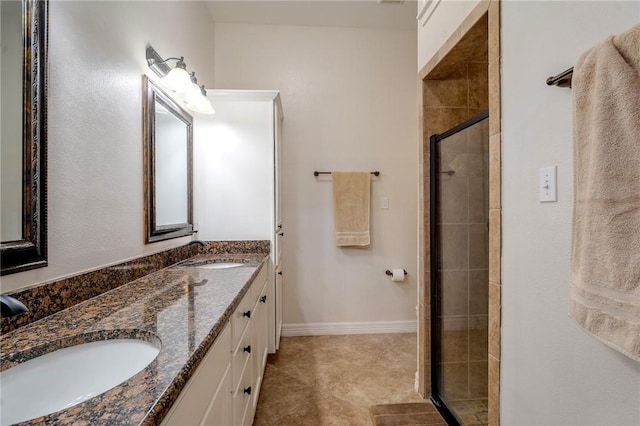 bathroom with tile patterned flooring, vanity, and an enclosed shower