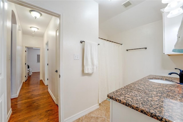 bathroom with hardwood / wood-style floors and vanity