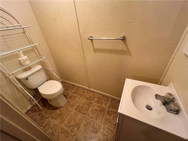 bathroom with tile patterned floors, vanity, and toilet