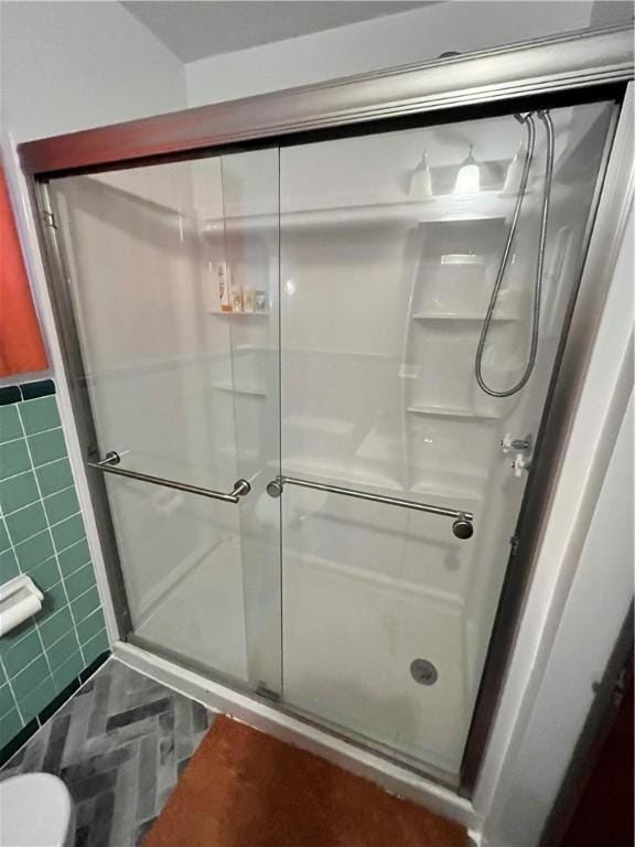 bathroom with tile walls and walk in shower