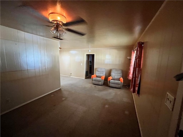 unfurnished room with ceiling fan and carpet