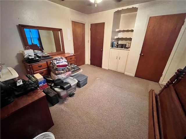 miscellaneous room featuring light colored carpet