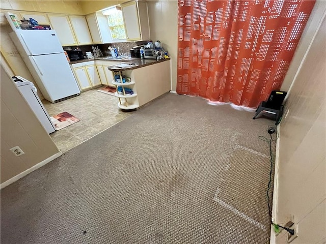 kitchen with sink and white fridge