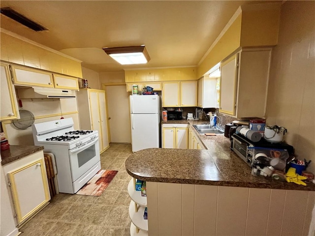 kitchen with kitchen peninsula, crown molding, sink, and white appliances